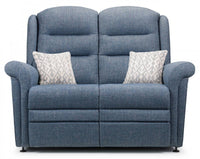 Blue fabric sofa with two patterned cushions on a white background
