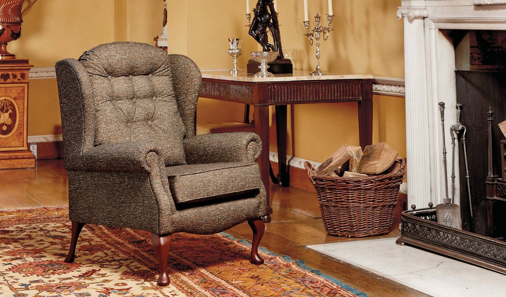 Chair in a room with a fireplace and table