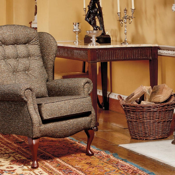 Chair in a room with a fireplace and table