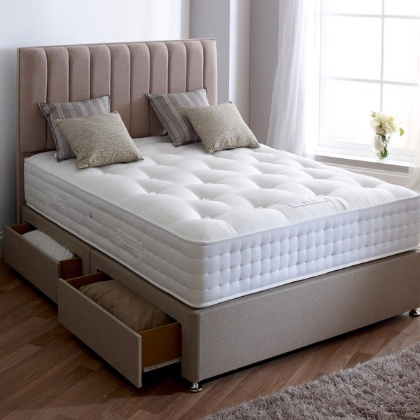 Beige upholstered bed with white mattress in a bedroom setting
