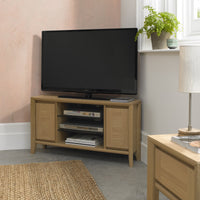 Wooden TV stand with a television in a living room setting.