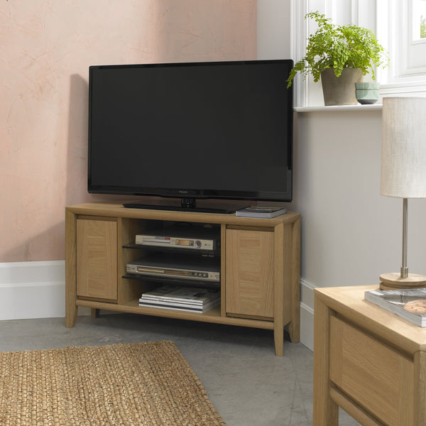 Wooden TV stand with a television in a living room setting.