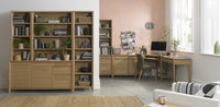 Home office with wooden bookshelves and desk.