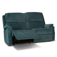 Reclining denim blue sofa with a white background