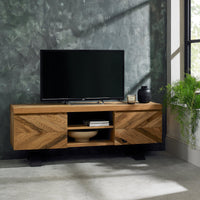 Wooden TV stand with a television and decorative items against a grey wall.
