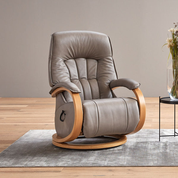 Grey recliner chair with wooden armrests on a wooden floor.