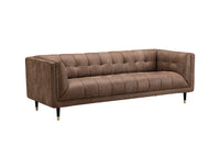 A three-seater sofa upholstered in brown tufted leather, featuring a modern low-profile design with tapered black legs and gold-toned tips, shown against a plain white background.