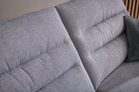 Grey fabric sofa with quilted pattern