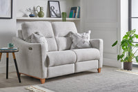 Grey sofa in a living room with a side table and decorative items.