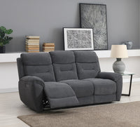 Grey sofa in a living room setting with books, a lamp, and wall art.