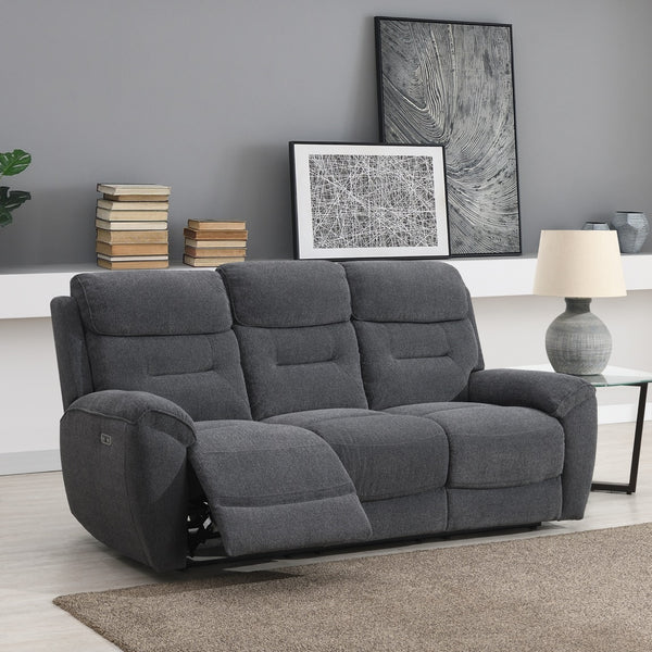 Grey sofa in a living room setting with books, a lamp, and wall art.