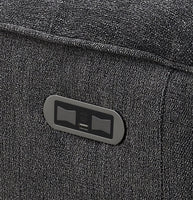 Close-up of a textured grey fabric surface with a small label.