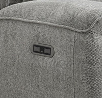 Grey textured fabric with a small logo or label on a close-up view