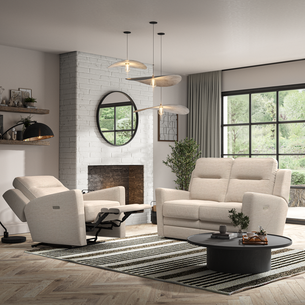 Modern living room with cream sofa, armchair, and coffee table.