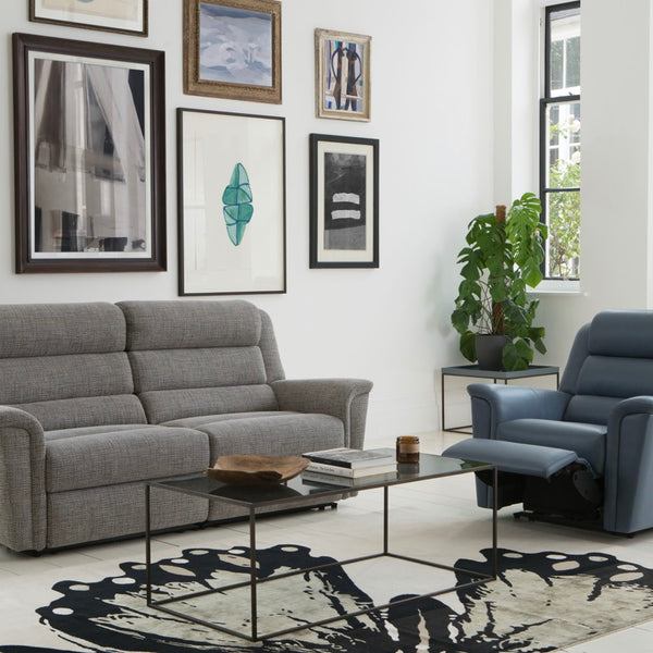 Living room with grey sofa, armchair, and decorative items.