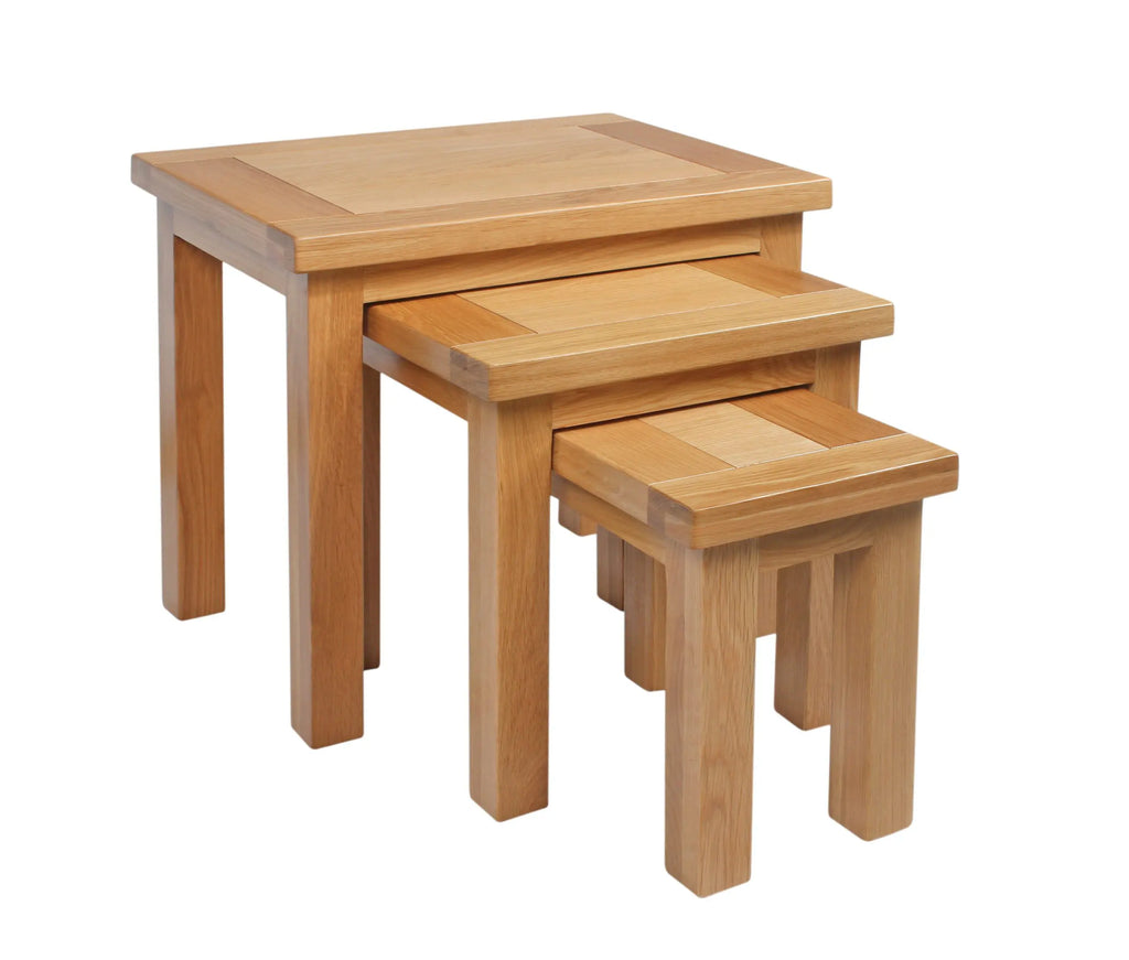 Set of three wooden nesting tables on a white background