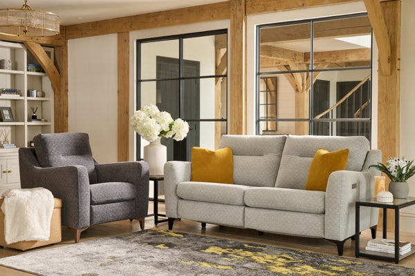 Living room with cream power sofa, armchair, and decorative elements.