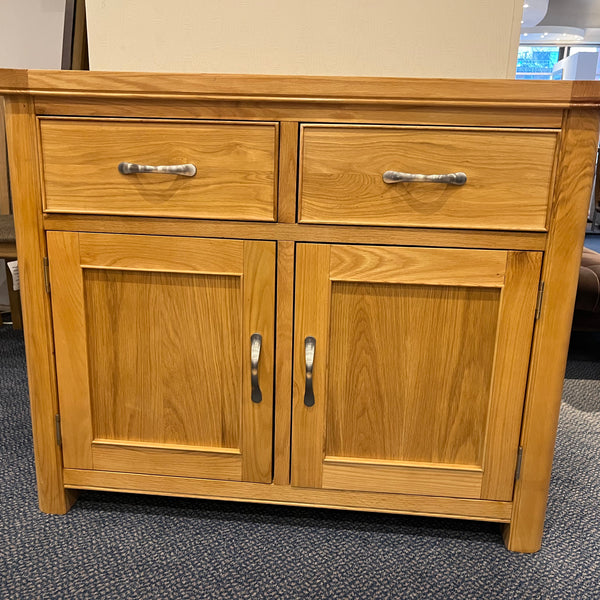 Wooden sideboard with drawers and doors in a room setting