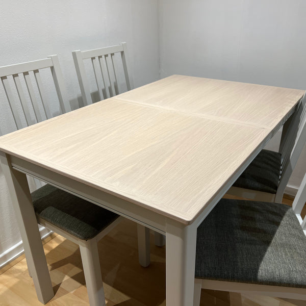 Dining table and chairs in a light washed beach colour