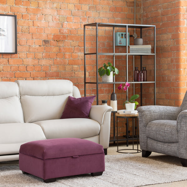 Modern living room with a white sofa, grey armchair, and purple ottoman.