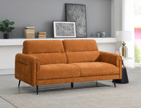 Orange sofa in a living room setting with decor elements.
