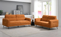 Two orange sofas in a modern living room setting with decor elements.