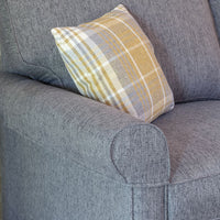 Grey sofa with a patterned yellow and grey pillow