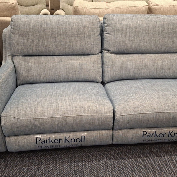 A light blue upholstered two-seater sofa with wide armrests, shown in a furniture showroom. The brand name 'Parker Knoll' is printed on the front of both seat cushions.
