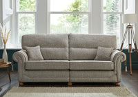 Grey sofa in a room with large windows and a lamp.