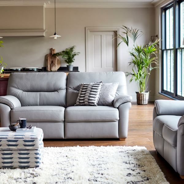 Modern living room with grey sofa, coffee table, and decorative elements.