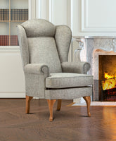 Grey armchair in a room with a fireplace