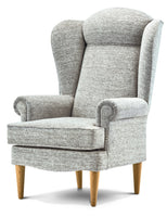 Grey upholstered wingback chair with wooden legs on a white background