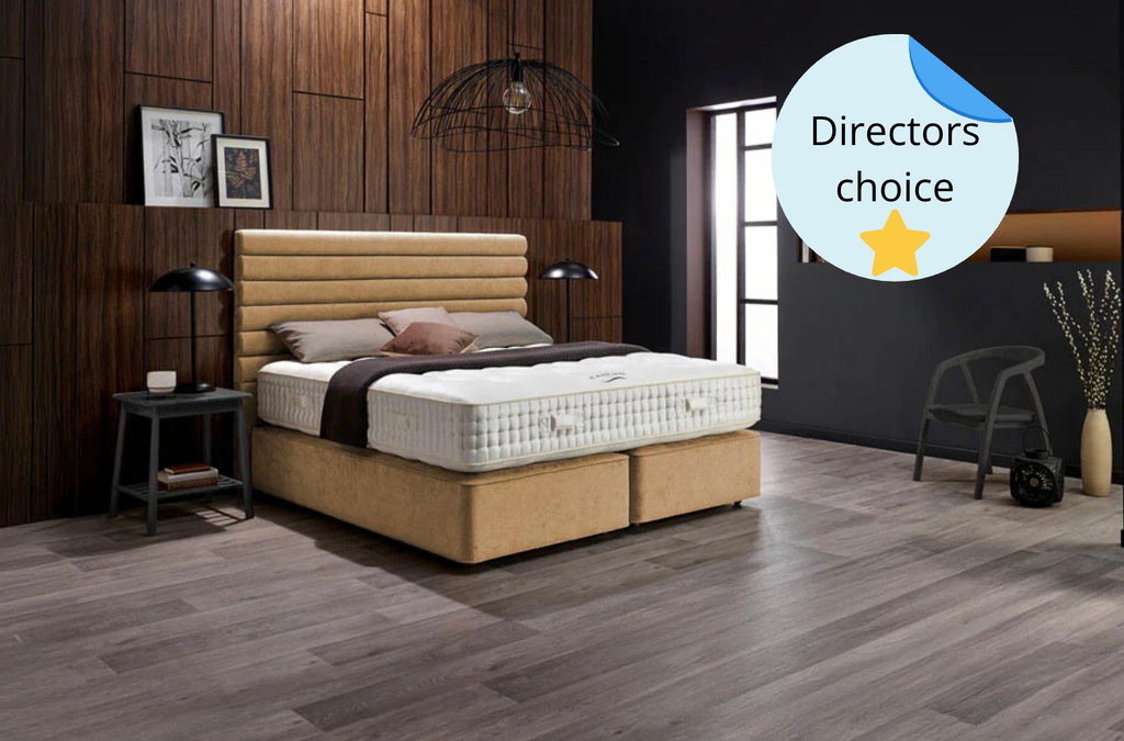 Bedroom with a bed and mattress, wooden flooring, and decorative elements.
