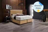 Bedroom with a bed and mattress, wooden flooring, and decorative elements.