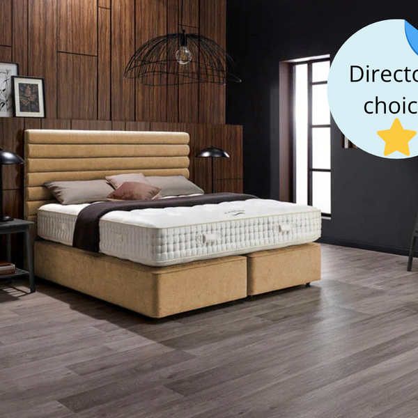 Bedroom with a bed and mattress, wooden flooring, and decorative elements.