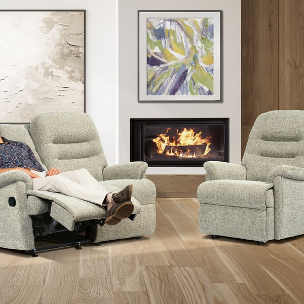 Man relaxing in a recliner chair in a living room with a fireplace.