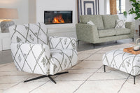 Living room with patterned chairs, green sofa, and a fireplace.