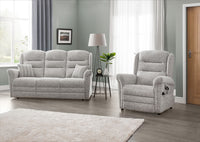 Grey sofa and armchair set in a living room with a lamp and plant.
