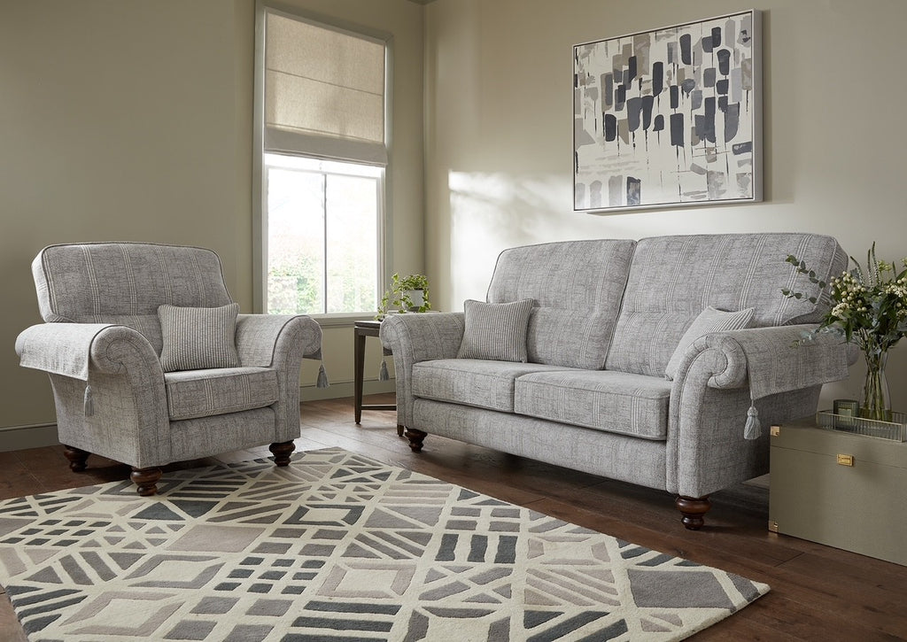 Living room with grey sofa and armchair on a patterned rug