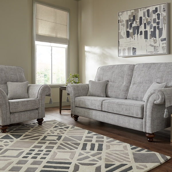 Living room with grey sofa and armchair on a patterned rug