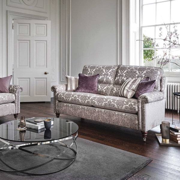 Living room with a patterned sofa, coffee table, and decorative pillows.