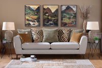 Living room with a grey sofa, decorative pillows, and wall art depicting mountains.