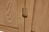 Close-up of a wooden cabinet with a visible hinge.