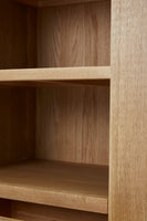 Close-up of a wooden bookshelf with shelves.