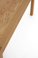 Close-up of a wooden table corner on a white background
