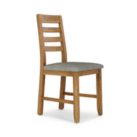 Wooden chair with a grey cushion on a white background