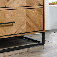 Wooden dresser with black metal legs on a wooden floor